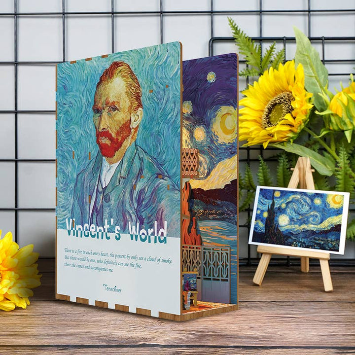 The DIY Book Nook Kit: Vincent's World by Hands Craft features a decorative Van Gogh bookshelf insert with his portrait and "Vincent's World" text, sunflowers, an easel with "Starry Night," all set against a grid-patterned wall.