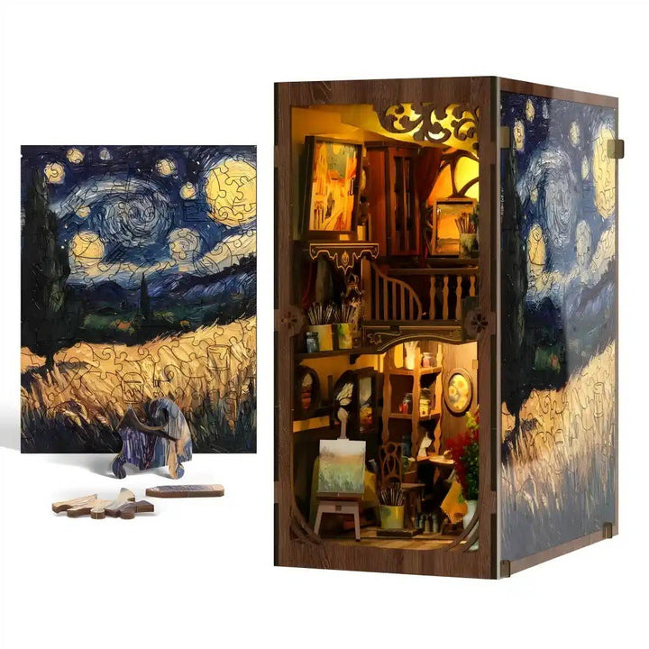The Hands Craft DIY Book Nook Kit: Golden Twilight Studio is a Van Gogh-inspired artist’s loft diorama with scattered puzzle pieces, housed in a wooden box and designed to transform your shelf into an enchanting miniature studio.