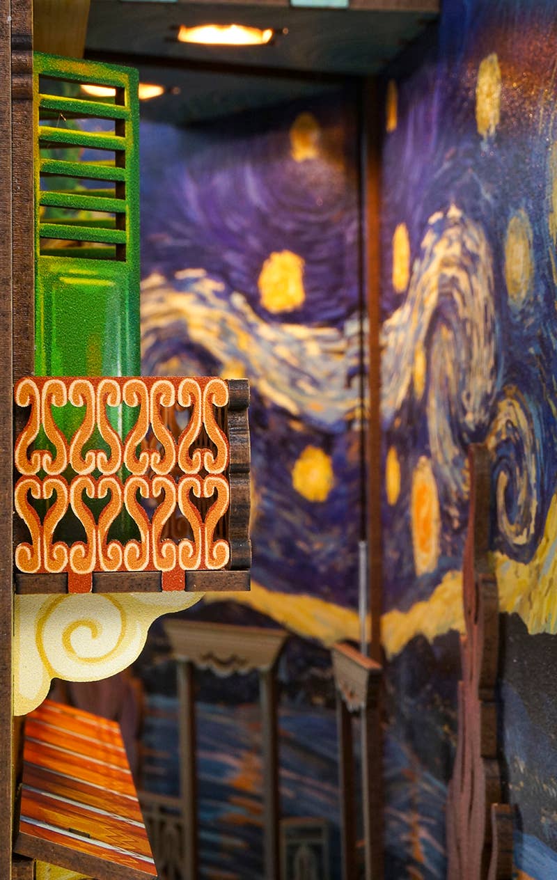 The Hands Craft DIY Book Nook Kit: Vincent's World features a colorful balcony with ornate railings and a "Starry Night" mural, creating a stunning Van Gogh bookshelf insert for art lovers and miniatures fans.