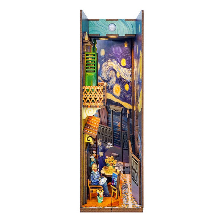 Hands Craft’s DIY Book Nook Kit: Vincent's World is a miniature diorama featuring a café scene with yellow tables and chairs, inspired by Van Gogh's art, and includes a night sky background reminiscent of "The Starry Night.