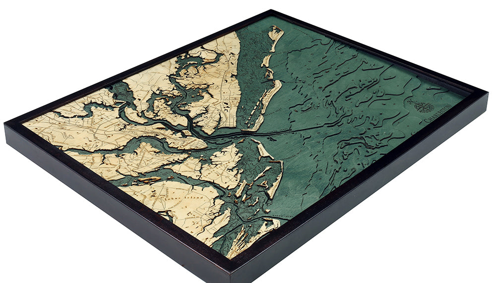 The WoodChart CharlstonSC 24.5 x 31 Black Frame is a framed, 3D layered wooden map in beige and green, displaying detailed land contours and waterways with a textured surface.