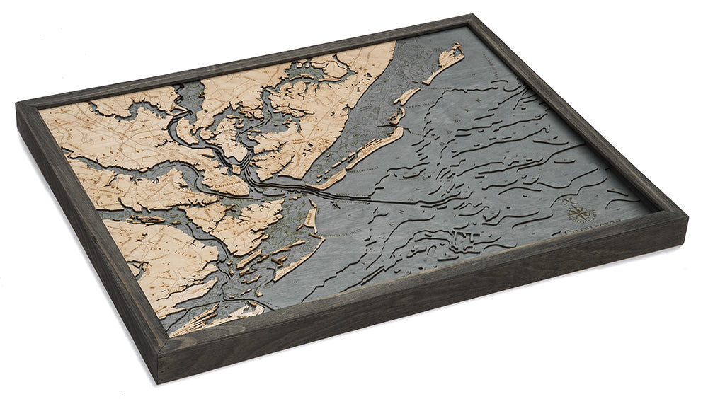 The WoodChart CharlstonSC 24.5 x 31 Grey Frame is a layered wooden map with engraved land and water details in natural wood and gray tones, showcasing coastal geography and topography in a stylish framed design.