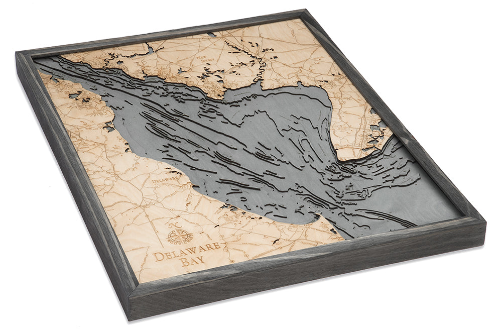 The WoodChart Delaware Bay 24.5 x 31 Grey Frame is a framed, layered wooden map featuring engraved geographic details of Delaware Bay and its surroundings, highlighted by light wood and gray accents, shown from a slight angle.