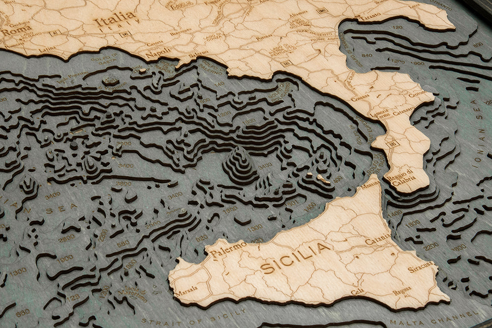WoodChart's Italy 24.5" x 31" Grey Frame is a detailed wooden topographic map of southern Italy and Sicily, featuring elevation lines, labeled cities like Palermo, Napoli, Roma, and the Tyrrhenian and Ionian Seas.
