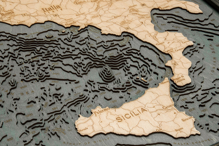 WoodChart's Italy 24.5" x 31" Grey Frame is a detailed wooden topographic map of southern Italy and Sicily, featuring elevation lines, labeled cities like Palermo, Napoli, Roma, and the Tyrrhenian and Ionian Seas.