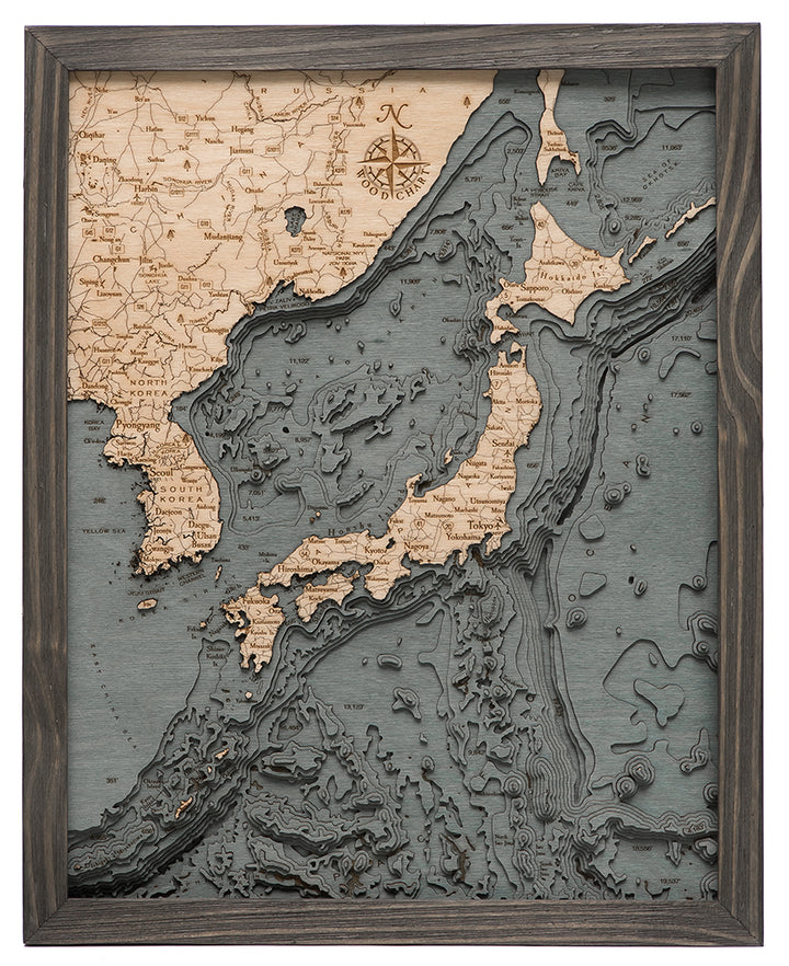 WoodChart's Japan Korea 16" x 20" Grey Frame features a layered wood map of Japan, nearby islands, and parts of Korea and China with lighter wood landmasses and dark, textured ocean details.