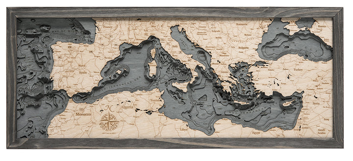 WoodChart’s Mediterranean Sea map (13.5" x 31") showcases detailed carvings of Europe, North Africa, and the Middle East, beautifully displayed in a rustic grey frame.