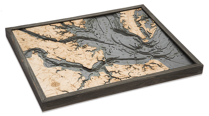 The WoodChart Norfolk VA 24.5 x 31 GreyFrame is a framed nautical wood map featuring laser-cut detail that highlights coastal land and water formations with raised land and recessed water for a striking 3D effect.