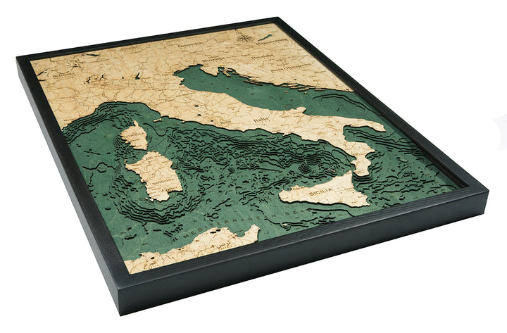 The WoodChart Italy 24.5" x 31" Black Frame displays a layered topographic map of Italy, Sicily, Sardinia, and nearby seas, featuring detailed elevation contours and water depths in green and beige tones.