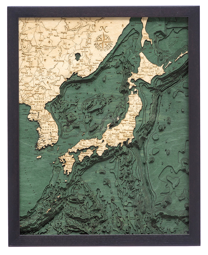 The WoodChart Japan Korea 16" x 20" Black Frame features a vintage-style, layered map detailing Japan, eastern China, and Russia with green and tan topography and ocean depths.