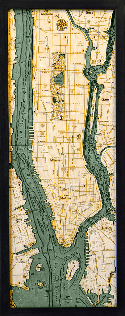 The WoodChart Manhattan 13.5" x 31" Black Frame displays a wood-carved map of Manhattan and nearby boroughs, with intricate street grids, Central Park, rivers, and labeled areas like Midtown, Upper East Side, Queens, and Brooklyn.