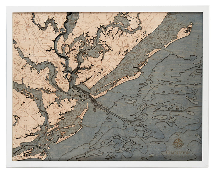 The WoodChart CharlstonSC 24.5 x 31 White Frame features a labeled topographical map of Charleston, South Carolina, with rivers, marshes, and coastline in beige and blue-gray tones plus a compass rose in the lower right corner.