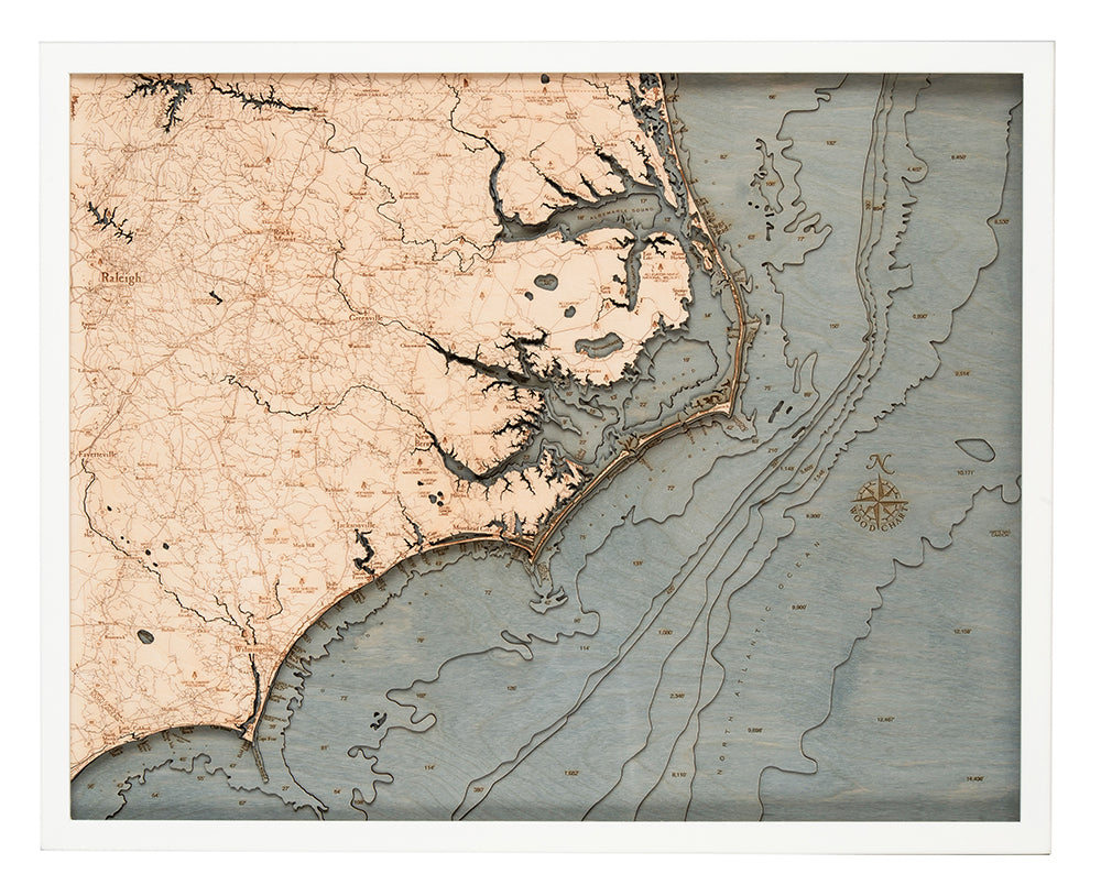 The WoodChart North Carolina Coast 24.5" x 31" White Frame features a vintage-inspired map of the NC coast and inland areas with roads, rivers, Atlantic Ocean, and intricate topographic and nautical details.