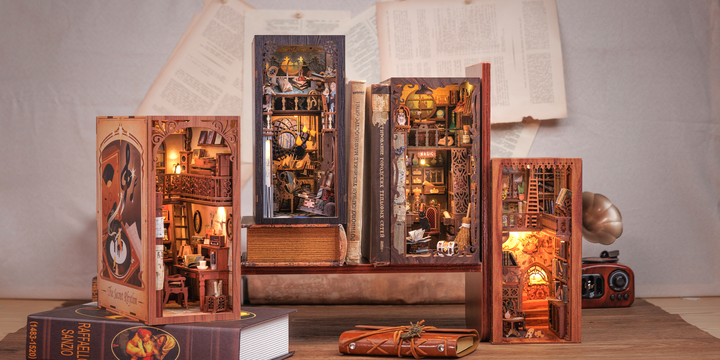 Five intricately designed Hands Craft DIY Book Nook Kits: Eternal Bookstore with Dust Cover are displayed among scattered books and papers, each creating a cozy, detailed mini interior—making an ideal literary gift.