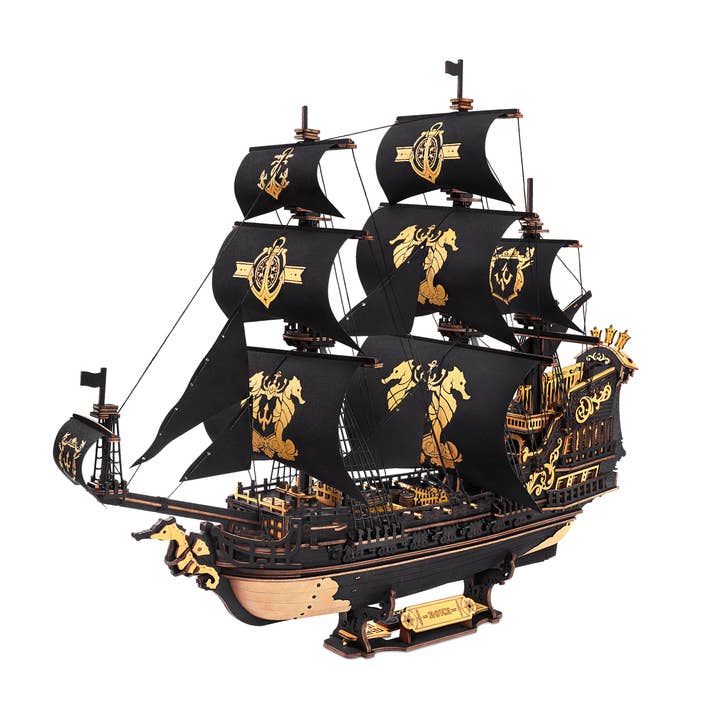 The Hands Craft DIY The Seahorse Barque Ship model features black sails with gold designs, wood accents, and multiple masts, shown against a plain white background.