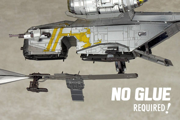 A close-up of the Mandalorian Razor Crest Star Wars Premium Metal Earth DIY kit from Metal Earth being assembled with tweezers. White text says, "NO GLUE REQUIRED!" Perfect for Star Wars model enthusiasts.