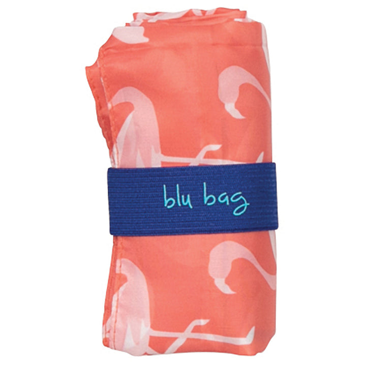 The Desert Flamingo Reusable Bag by zzzRockFlowerPaper is an eco-friendly, folded reusable shopping bag adorned with a lively flamingo pattern. It is neatly secured with a dark blue strap featuring the "blu bag" label, combining style and sustainability for your everyday needs.