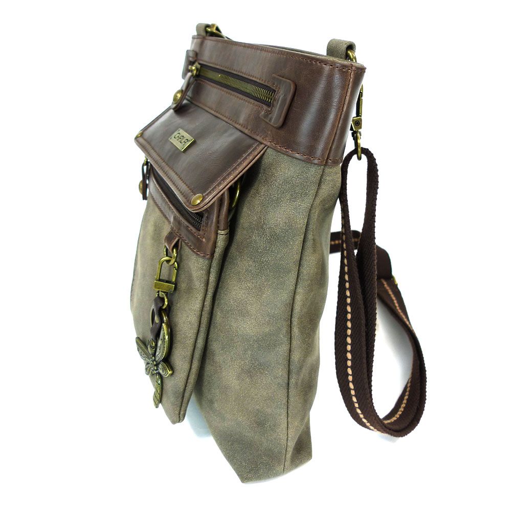 The Gemini Xbody w DF Stone by Chala is a stylish brown and olive crossbody bag made from faux leather, featuring a long adjustable strap. It includes a detachable front pocket with a zipper, decorative clasp and buckle details, and an elegant dragonfly keychain accent.