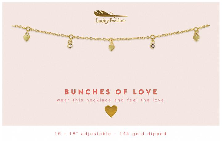 Introducing the "Dangle Necklace Love" by LuckyFeather: This exquisite necklace boasts a 14k gold-plated delicate chain adorned with charming heart accents and sparkling crystals. Adjustable from 16 to 18 inches, it’s designed to make you feel cherished every time you wear it. The text reads, "BUNCHES OF LOVE - wear this necklace and feel the love." Adorn yourself with a touch of elegance from LuckyFeather.