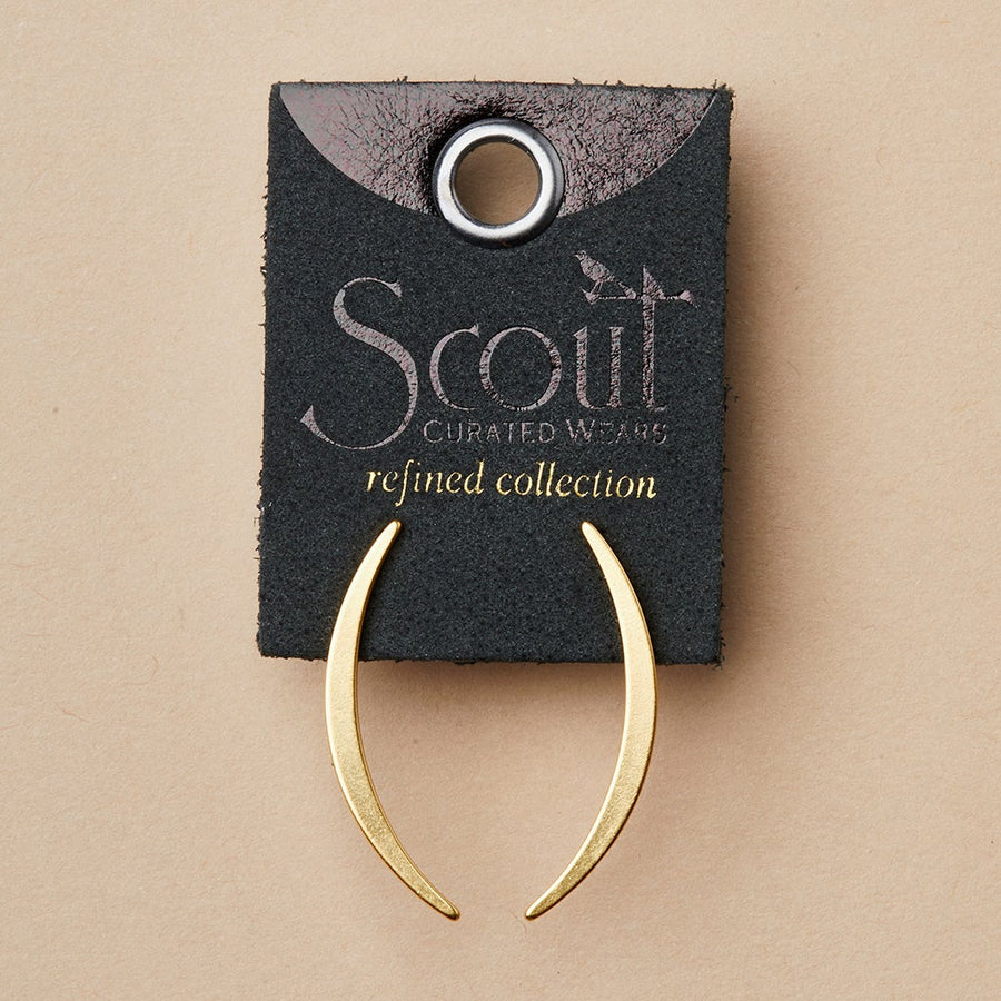 The Gibbous Slice Stud Gold earrings, from the Refined Earring Collection by Scout Jewelry, are displayed on a dark tag labeled "Scout Refined Collection" against a beige background. These earrings are meticulously crafted from 18k gold vermeil.