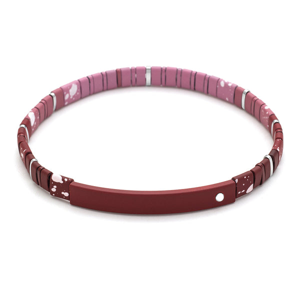 The Good Karma Ombre Gratitude Mulberry Silver bracelet from Scout Jewelry is a stylish piece featuring matte ombre tile beads in various shades of pink and white speckled patterns. The bracelet has cylindrical beads, a clasp, and a small round charm. Its modern design is suitable for various occasions and carries empowering messages.