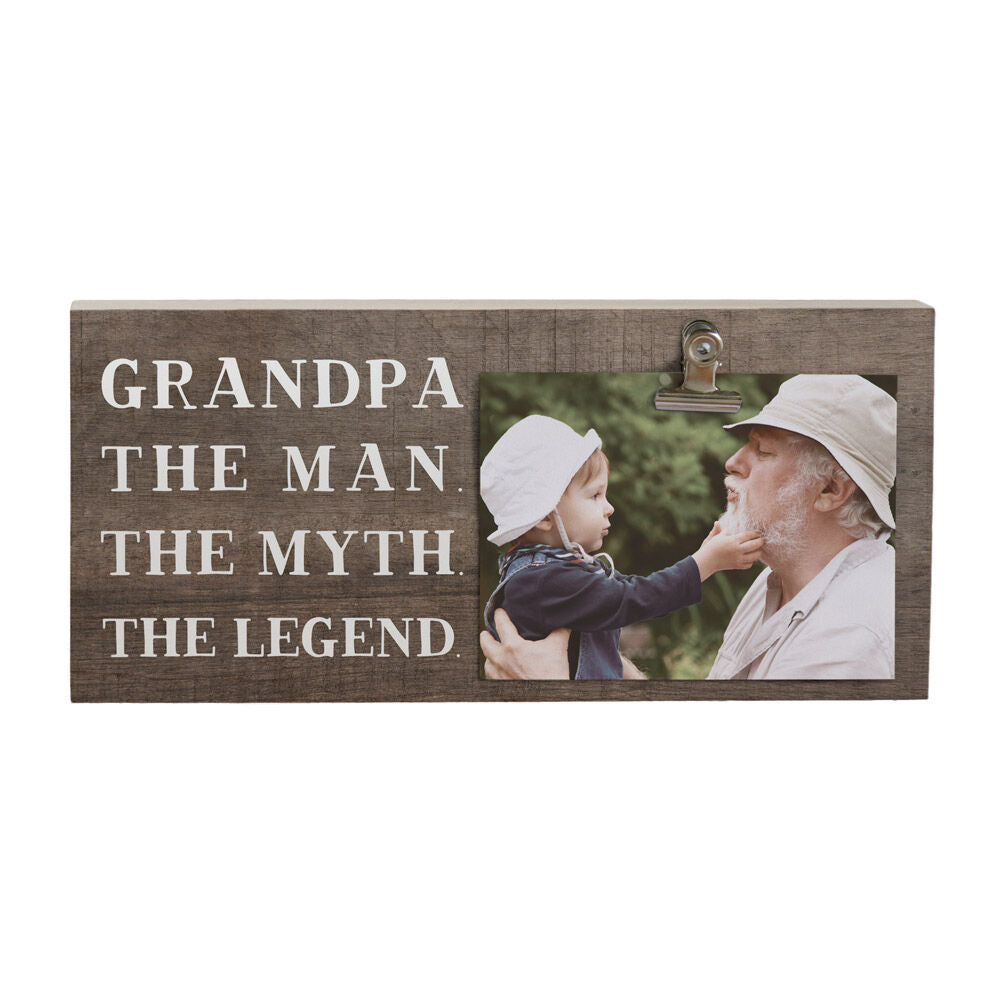 The "Grandpa The Man Photo" by SincereSurroundings is a handcrafted wooden plaque showcasing the text "Grandpa: The Man. The Myth. The Legend." It features a heartwarming photo of a man and a child in hats, captured in Rock Rapids, IA, with the child gently touching the man's chin, making it a charming photo clipboard keepsake.