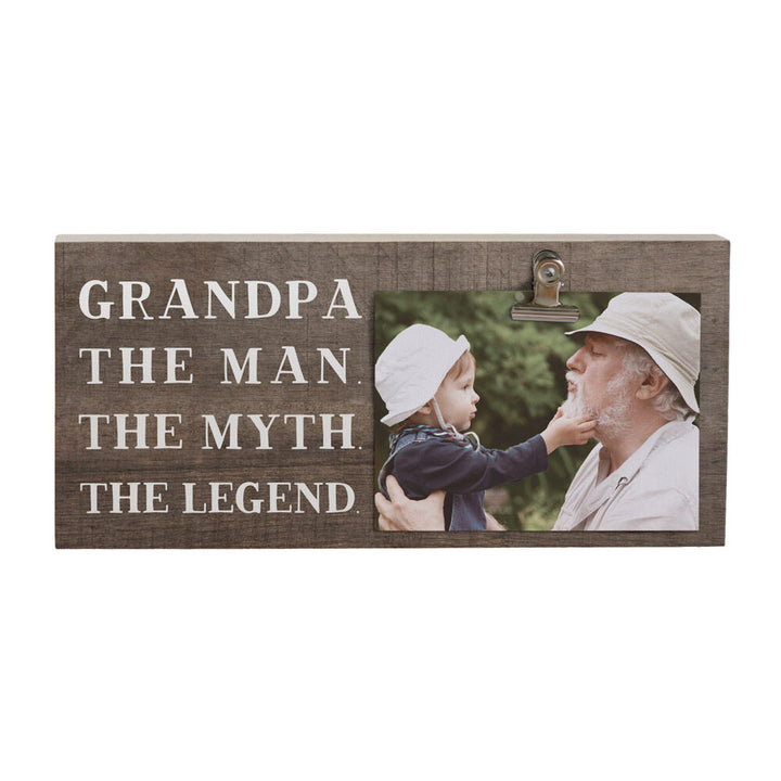 The "Grandpa The Man Photo" by SincereSurroundings is a handcrafted wooden plaque showcasing the text "Grandpa: The Man. The Myth. The Legend." It features a heartwarming photo of a man and a child in hats, captured in Rock Rapids, IA, with the child gently touching the man's chin, making it a charming photo clipboard keepsake.