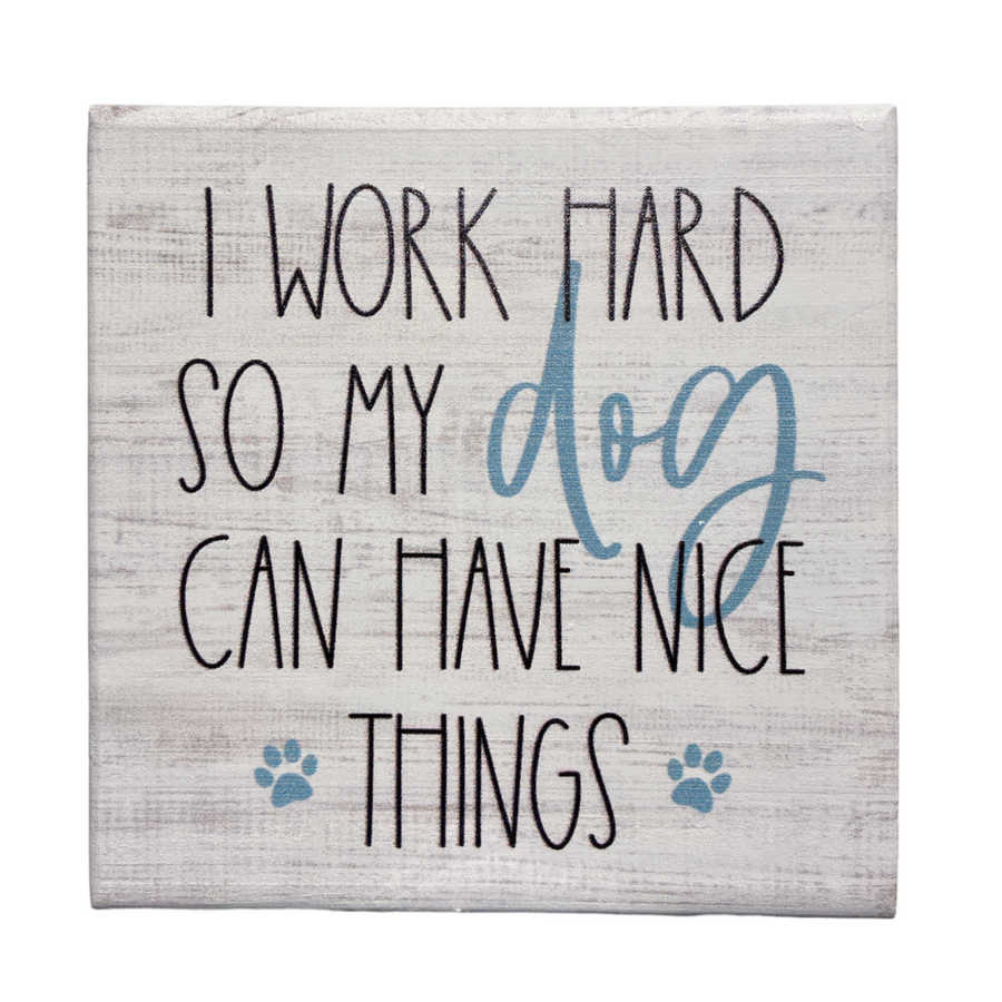Introducing the "Have Nice Things" decorative sign by SincereSurroundings. This handcrafted piece features the phrase "I work hard so my dog can have nice things" in elegant black and blue lettering, complemented by two small paw prints at the bottom. Perfect for shelf displays, it brings a charming touch to any space. Lovingly made in Rock Rapids, IA.