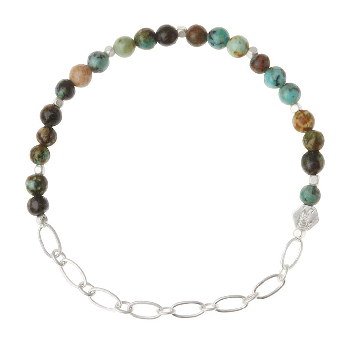 The Scout Jewelry Chain Bracelet African Turq/Silver features multicolored semi-precious gemstones, a silver chain section, and an engraved hexagonal charm.