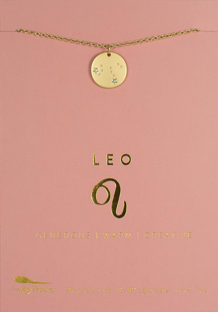 Displayed beautifully on a pink card, the LuckyFeather Zodiac Necklace Leo features a round pendant adorned with small stars. The card includes the Leo symbol along with the words "Generous | Warm | Creative." This exquisite necklace is "14k gold dipped" and comes with an adjustable chain length of "16-18 inches.