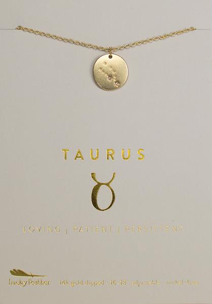 A Zodiac Necklace Taurus boasts a lustrous gold-dipped zodiac pendant. The packaging elegantly displays "Taurus" with the traits "Loving | Patient | Persistent" in shining gold text against a soft cream backdrop. At the bottom, the brand name "LuckyFeather" adds the finishing touch to this beautiful piece of Zodiac Jewelry.