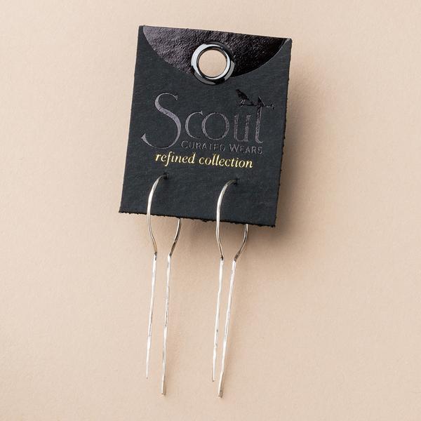 A pair of elegant Equinox Keyhole Hoop Silver earrings by Scout Jewelry is displayed on a dark card featuring the text "Scout Curated Wears - Refined Collection." These hypoallergenic, nickel-free beauties stand out against a light tan background.