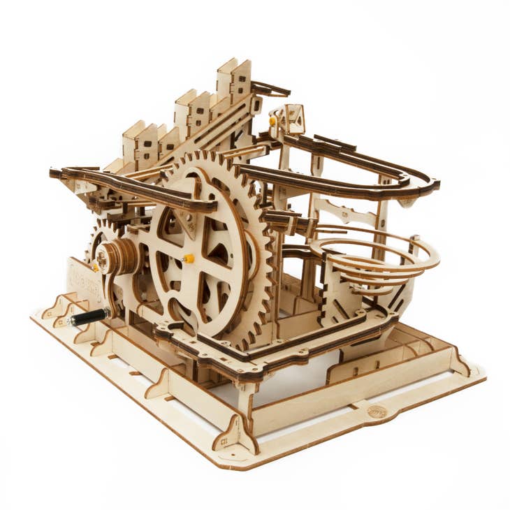 The DIY Marble Run Parkour by Hands Craft is a captivating 3D wooden puzzle featuring gears, winding tracks, and structures. Its intricate design allows marbles to glide seamlessly, echoing the charm of a waterwheel coaster against a plain background.